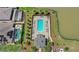 Aerial view of a community pool, featuring a large swimming area, lounge chairs, and lush landscaping at 5641 Oak Knoll Dr, St Cloud, FL 34771