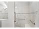 Walk-in shower with neutral tile, grab bars, built in shelving and dual shower heads at 5641 Oak Knoll Dr, St Cloud, FL 34771