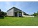 Back exterior view showcasing the well-maintained backyard, patio, and fenced property line at 5908 Paxton Ct, Apopka, FL 32703