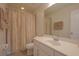 Clean bathroom featuring a single vanity, toilet, and a shower with a neutral-toned shower curtain at 5908 Paxton Ct, Apopka, FL 32703