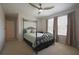 Inviting bedroom with wrought iron bed frame, neutral walls, and large windows for plenty of natural light at 5908 Paxton Ct, Apopka, FL 32703