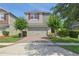 Two-story home with red shutters, two-car garage, brick paver driveway, and nicely landscaped front yard at 5908 Paxton Ct, Apopka, FL 32703