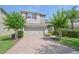 Two-story home with red shutters, two-car garage, brick paver driveway, and neatly landscaped front yard at 5908 Paxton Ct, Apopka, FL 32703