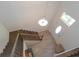 Bright foyer featuring a view of the wooden staircase, light fixture, and front door at 5908 Paxton Ct, Apopka, FL 32703