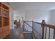 Upstairs hallway featuring hardwood floors and a wood banister at 5908 Paxton Ct, Apopka, FL 32703