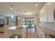 Open-concept kitchen with stainless steel appliances, granite countertops, and an adjacent dining and living area at 5908 Paxton Ct, Apopka, FL 32703