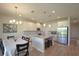 Modern kitchen and dining area with granite countertops, stainless steel appliances, a center island, and pendant lighting at 5908 Paxton Ct, Apopka, FL 32703