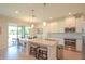 Bright, modern kitchen with granite countertops, stainless steel appliances, a center island, and an adjacent dining area at 5908 Paxton Ct, Apopka, FL 32703