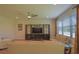 Bright living room features a large TV, stylish furniture, and a decorative area rug at 5908 Paxton Ct, Apopka, FL 32703