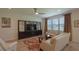 Bright living room features a large TV, stylish furniture, and a decorative area rug at 5908 Paxton Ct, Apopka, FL 32703