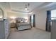 Bright main bedroom featuring neutral decor, large windows, and a ceiling fan for added comfort at 5908 Paxton Ct, Apopka, FL 32703