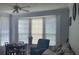 Bright living room with large bay window, dining table, and comfortable seating at 6316 Raleigh St # 401, Orlando, FL 32835