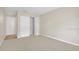 Bedroom with neutral carpet, white trim, bi-fold closet and a secondary door at 648 Kenwick Cir # 102, Casselberry, FL 32707