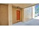 A front door with neutral walls and flooring and an overhang on a sunny day at 648 Kenwick Cir # 102, Casselberry, FL 32707