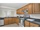 Kitchen featuring wooden cabinets, granite counters, stainless appliances and tile backsplash at 648 Kenwick Cir # 102, Casselberry, FL 32707