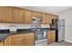 Cozy kitchen featuring stainless steel appliances, granite counter tops and tile backsplash at 648 Kenwick Cir # 102, Casselberry, FL 32707