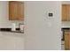 A kitchen featuring white appliances and light wood cabinets at 648 Kenwick Cir # 102, Casselberry, FL 32707