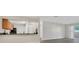 Open-concept living room featuring neutral walls, granite counter tops and a sliding glass door at 648 Kenwick Cir # 102, Casselberry, FL 32707
