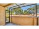 A covered patio with a screen door and view of trees and a parking lot at 648 Kenwick Cir # 102, Casselberry, FL 32707