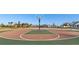 Community basketball court featuring a bright blue hoop and a well-maintained court, with a glimpse of the neighborhood at 700 Trotters Dr, Eagle Lake, FL 33839