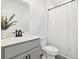 Clean bathroom featuring a modern vanity, minimalist decor, and a shower with white curtain at 700 Trotters Dr, Eagle Lake, FL 33839