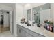 Bathroom with a dual sink vanity with black hardware, two mirrors and a glass enclosed shower at 700 Trotters Dr, Eagle Lake, FL 33839