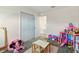 Bright bedroom featuring a plush pink rug and a variety of toys, including a dollhouse and plush Minnie Mouse at 700 Trotters Dr, Eagle Lake, FL 33839