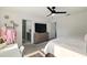 Bright bedroom features a ceiling fan, ensuite bathroom access, and closet access at 700 Trotters Dr, Eagle Lake, FL 33839