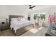 Bright bedroom with large windows, a ceiling fan, a vanity with a mirror, and contemporary decor at 700 Trotters Dr, Eagle Lake, FL 33839