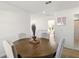 Bright dining area features a round wooden table with seating for four and stylish decor at 700 Trotters Dr, Eagle Lake, FL 33839