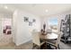 Bright dining area features a round wooden table with seating for four, adjacent to a bedroom, and ladder shelf at 700 Trotters Dr, Eagle Lake, FL 33839