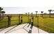 Fenced dog park with green grass and multiple stations for pet waste disposal at 700 Trotters Dr, Eagle Lake, FL 33839