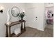 Welcoming foyer featuring a wooden console table, decorative mirror, sconces, and an inviting view into the study at 700 Trotters Dr, Eagle Lake, FL 33839