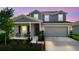 Charming two-story home with a covered front porch and a well-manicured lawn at 700 Trotters Dr, Eagle Lake, FL 33839