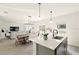 Open-concept kitchen featuring stainless steel appliances, modern fixtures, and seamless integration with living area at 700 Trotters Dr, Eagle Lake, FL 33839