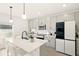 Modern kitchen featuring gray cabinets, a center island with seating, and stainless steel appliances at 700 Trotters Dr, Eagle Lake, FL 33839