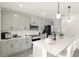 Bright kitchen featuring gray cabinets, a large center island with bar seating, and modern appliances at 700 Trotters Dr, Eagle Lake, FL 33839