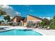 Community pool and clubhouse with ample seating and room for activities for residents at 700 Trotters Dr, Eagle Lake, FL 33839