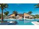 Community pool and clubhouse with palm trees, lounge chairs, and plenty of space for residents at 700 Trotters Dr, Eagle Lake, FL 33839