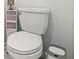 Toilet with tank on top, and a gray trash can on the side at 700 Trotters Dr, Eagle Lake, FL 33839