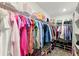Spacious walk-in closet well organized with rods for hanging clothes, and shelves for shoes and handbags at 700 Trotters Dr, Eagle Lake, FL 33839