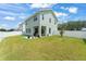 Spacious backyard with lush lawn, putting green, and patio with outdoor seating at 701 Dennis Ave, Orlando, FL 32807