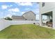 Wide view of the backyard has green grass, putting green and covered patio at 701 Dennis Ave, Orlando, FL 32807