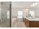 Bright bathroom featuring a glass enclosed shower, soaking tub, and double vanity at 701 Dennis Ave, Orlando, FL 32807