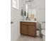 Stylish half-bathroom featuring a modern vanity with sink and a toilet at 701 Dennis Ave, Orlando, FL 32807