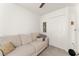 Cozy bedroom featuring a comfortable sofa, closet, and neutral decor at 701 Dennis Ave, Orlando, FL 32807