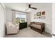 Cozy Bedroom featuring a crib, rocking chair, dresser, and a bright window at 701 Dennis Ave, Orlando, FL 32807