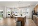 A bright open floor plan features a dining area, kitchen with island, and stainless steel appliances at 701 Dennis Ave, Orlando, FL 32807