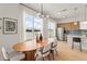 Open-concept dining area with stylish lighting, and stainless steel appliances at 701 Dennis Ave, Orlando, FL 32807