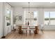Bright dining room with a modern chandelier, large windows and elegant decor at 701 Dennis Ave, Orlando, FL 32807